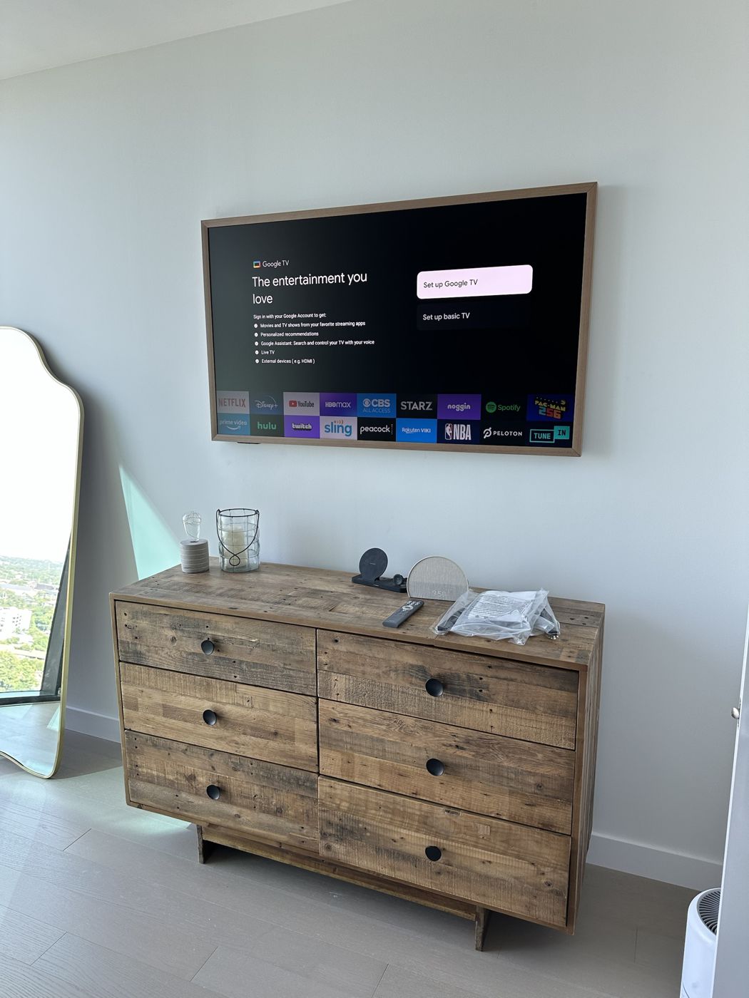 Samsung Frame TV above a dresser with a clean wall