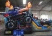 Monster-truck themed combo bounce house with slide