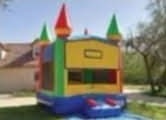 Castle-style moonwalk bounce house set up in a yard